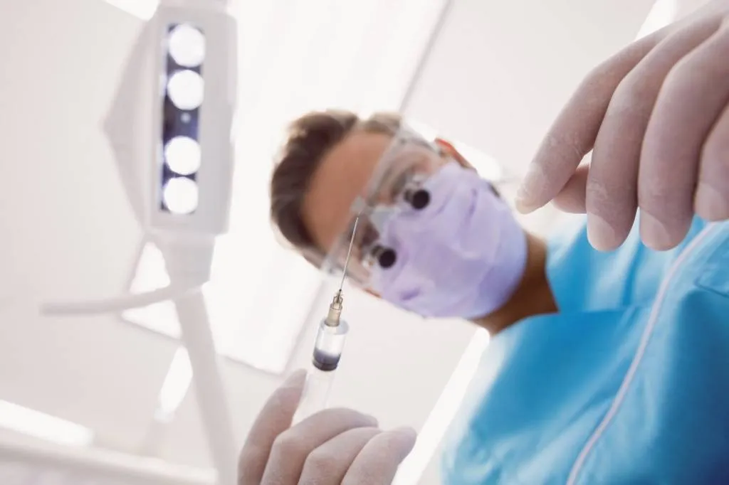 dentist-holding-dental-tools_107420-65524.jpg