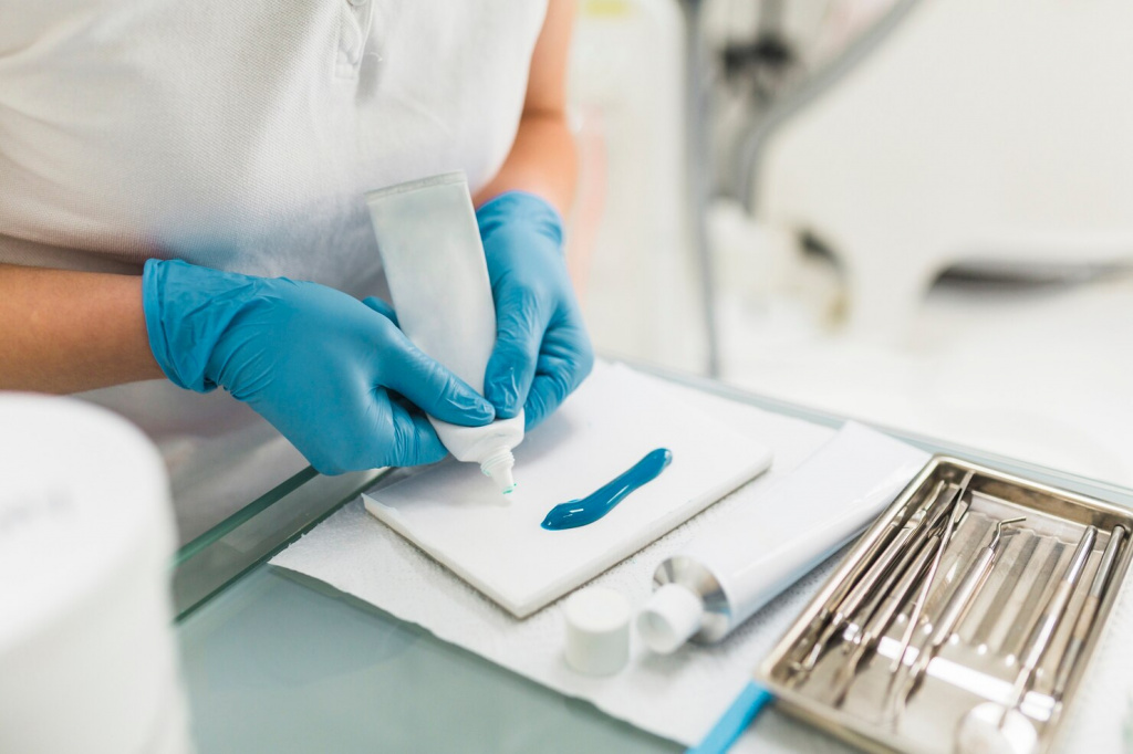 dental-technician-s-hand-removing-silicon-impression-material-from-tube_23-2147862103.jpg