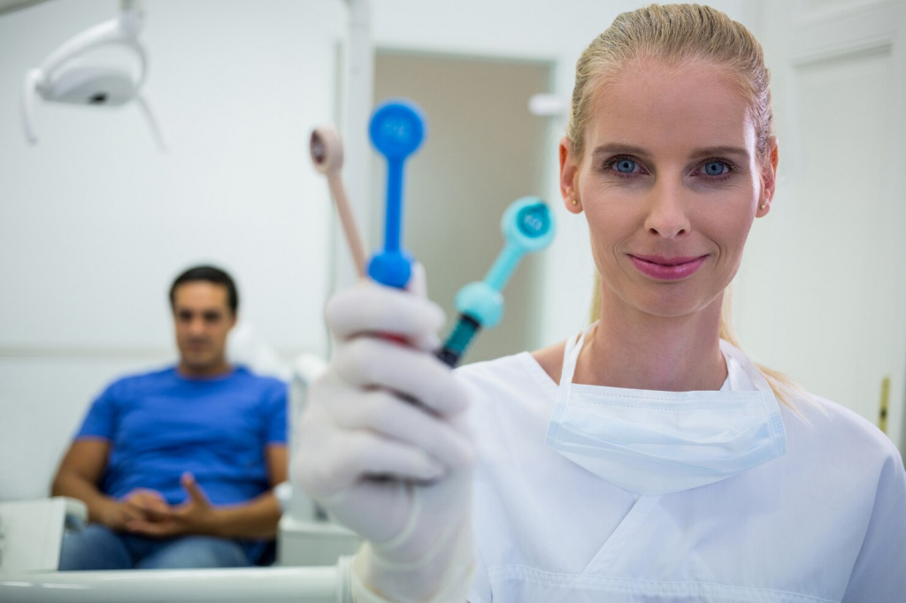 smiling-dentist-holding-dental-tools_107420-73940.jpg